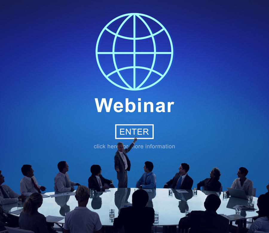 A group of people watching a webinar presentation.